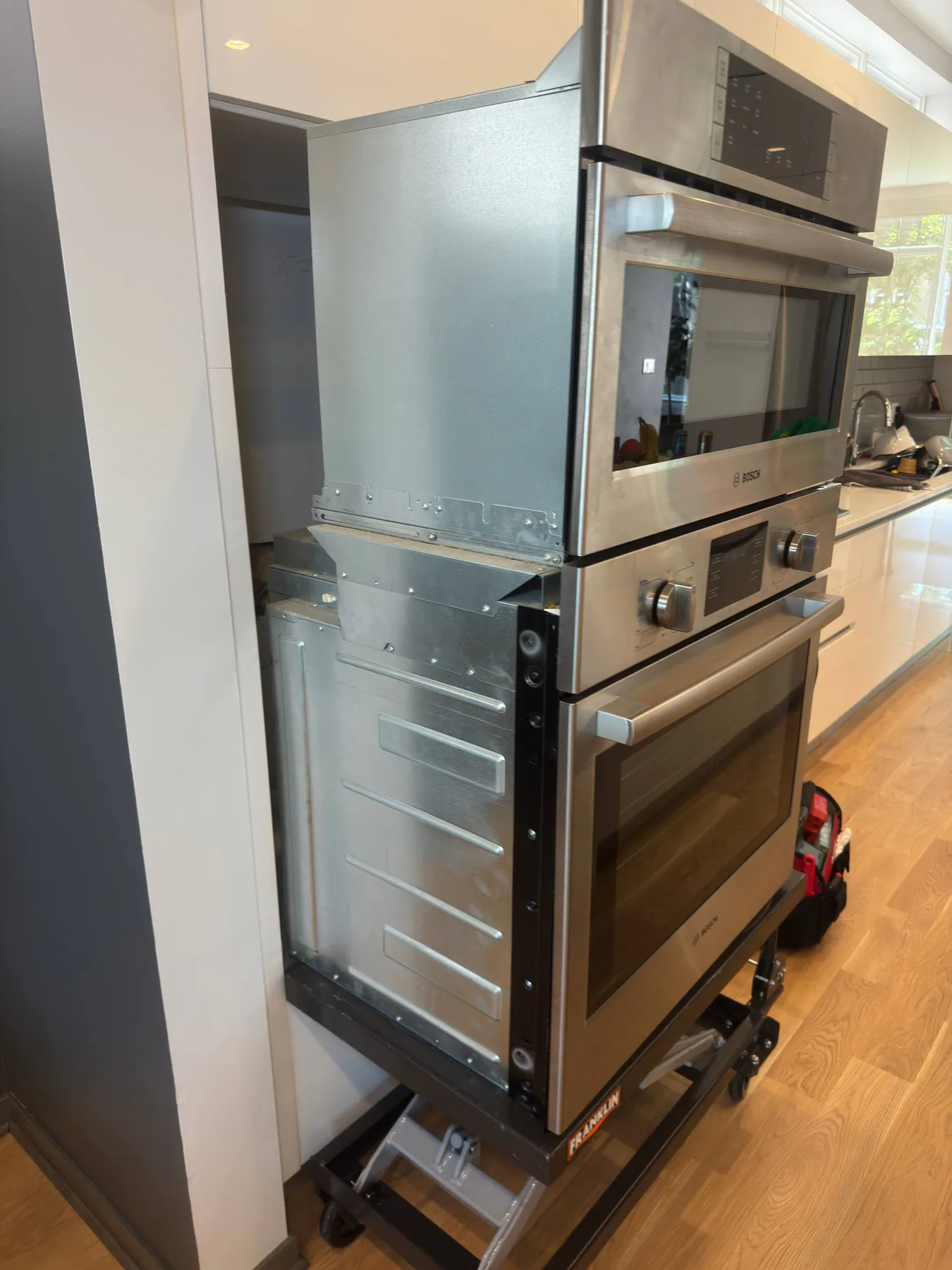 Wall oven pulled from cabinetry for service