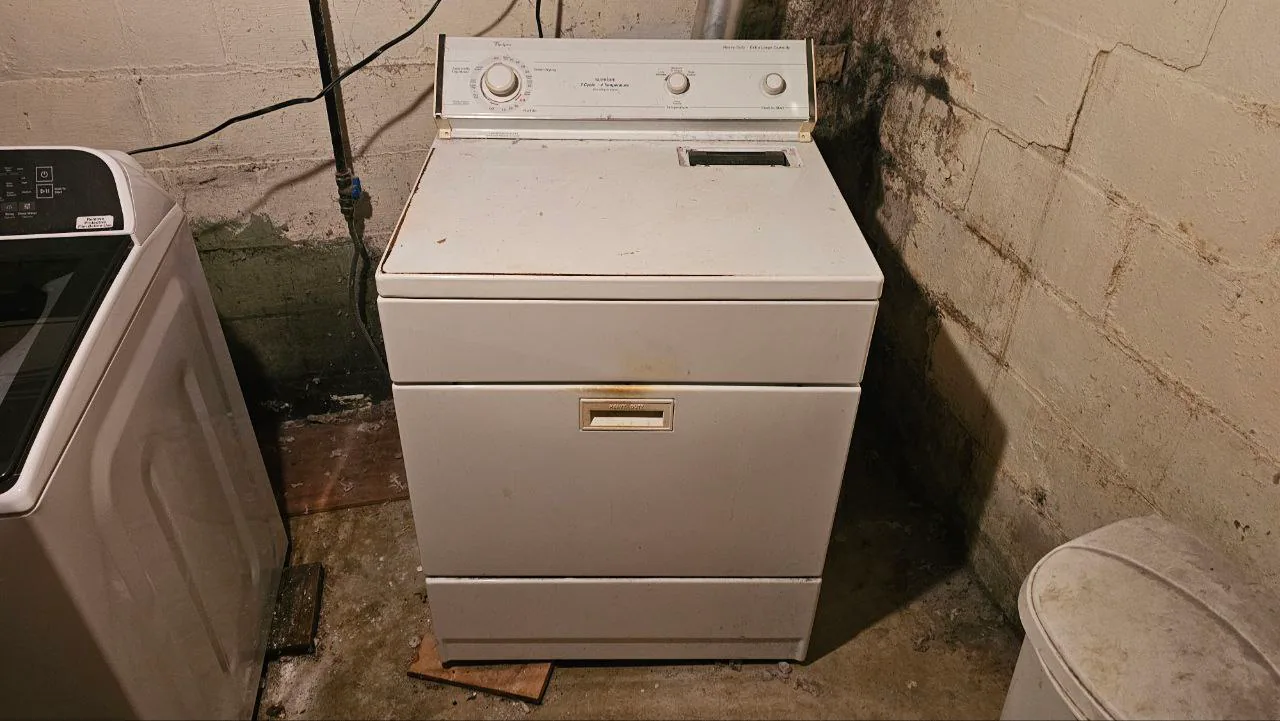Residential dryer inspected in a laundry area