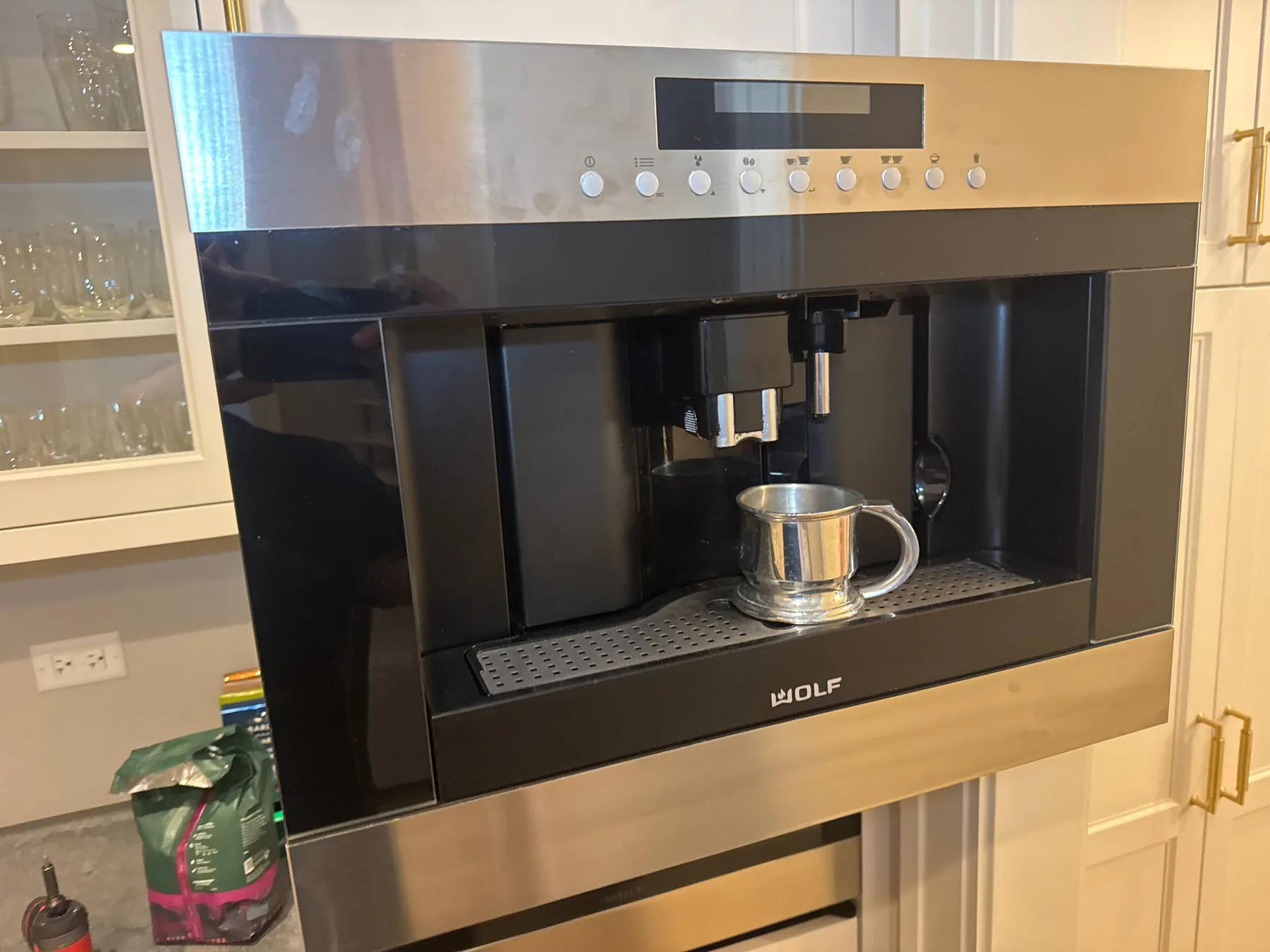 Wolf built-in coffee system in residential kitchen cabinetry